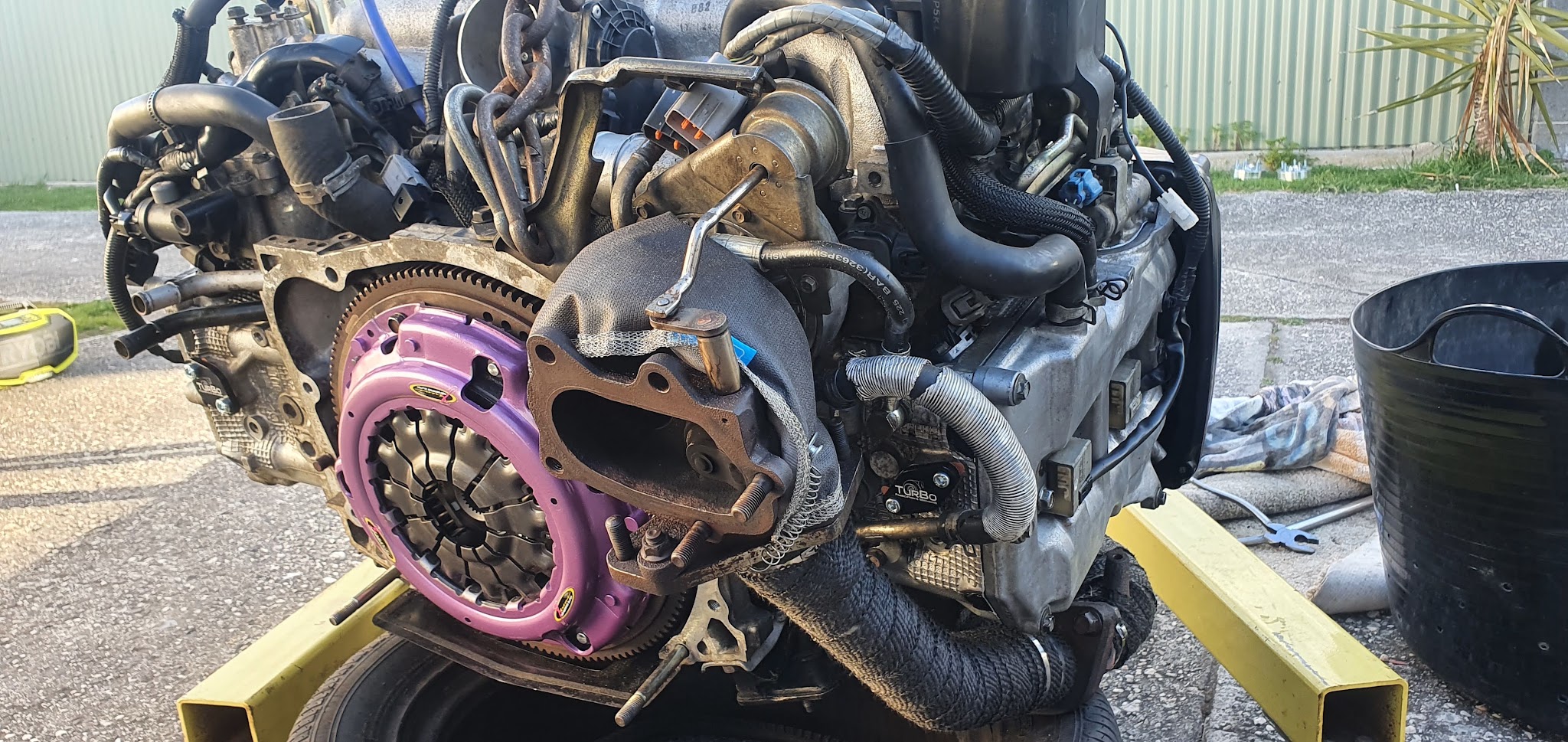 A Subaru boxer engine out of the car with the gearbox off and a new clutch fitted