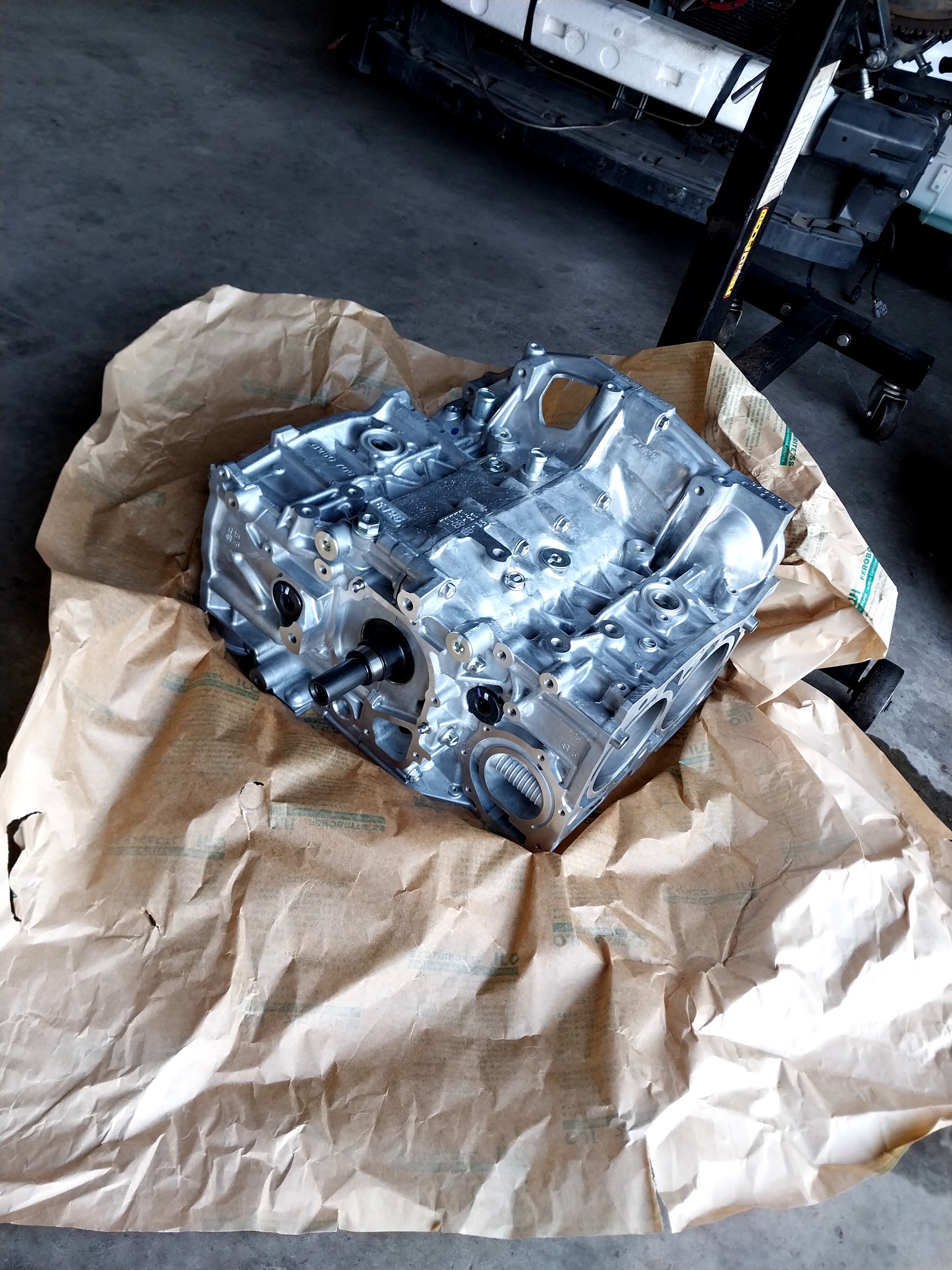 A bare Subaru boxer short block on the workshop floor, ready to be built up