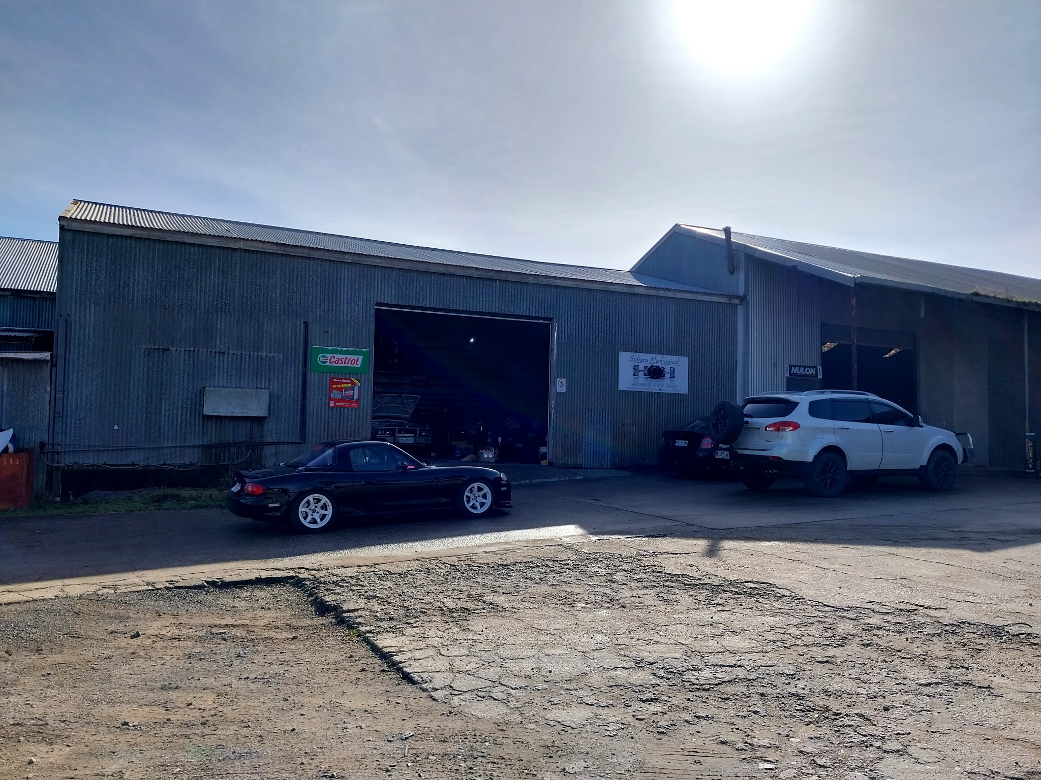 The Subaru Mechanical sheds on Faulkner Drive with cars parked outside